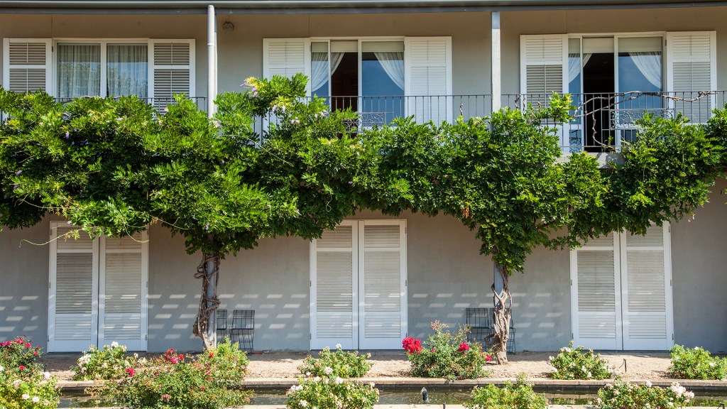Image of green vines winding their way across the Lancemore Milawa hotel facade with heritage white shutter windows, one of country Victoria's best luxury accommodation - Luxury Escapes