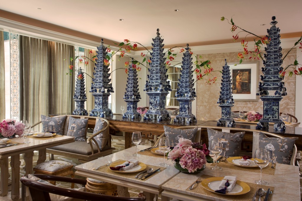 Balinese-inspired decoration at the Table8 restaurant in the Mulia Bali, with a lavish table setting and pink flowers