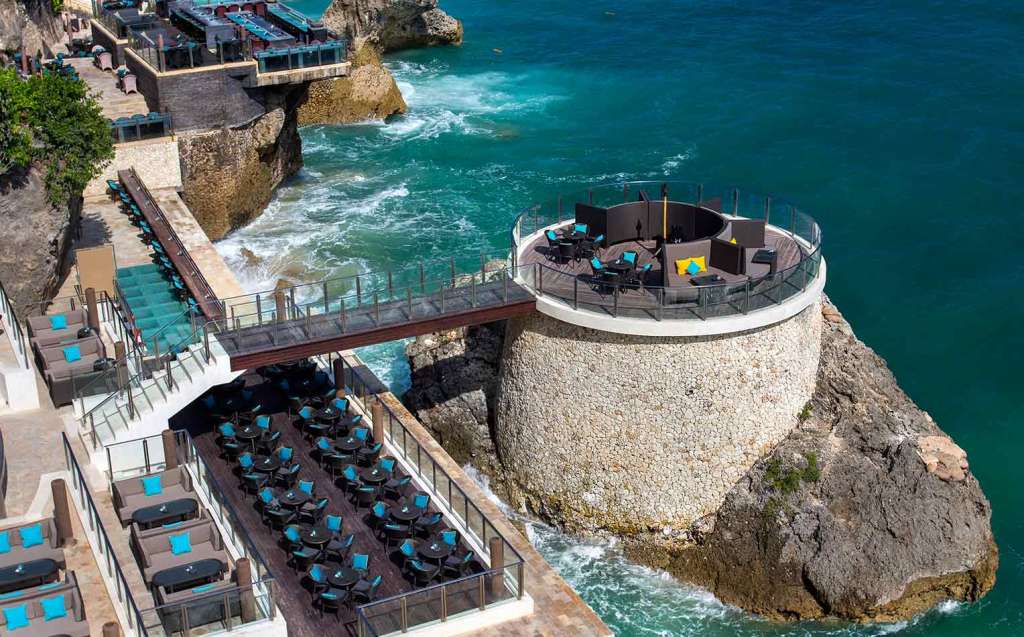 An image of the Rock Bar Bali overlooking the waves crashing against the rocks - Luxury Escapes