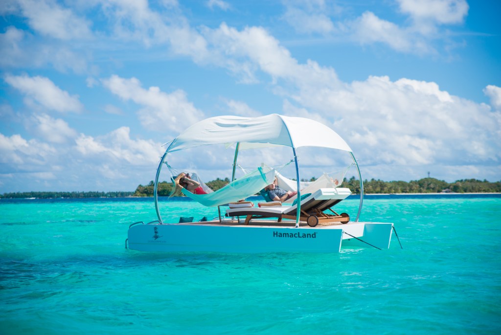 A floating hammock in the middle of a lagoon at Lily Beach Resort & Spa, a unique experience in the Maldives