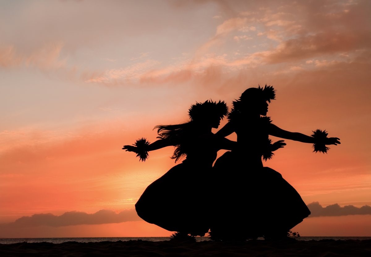 Hula girls dancing at sunset