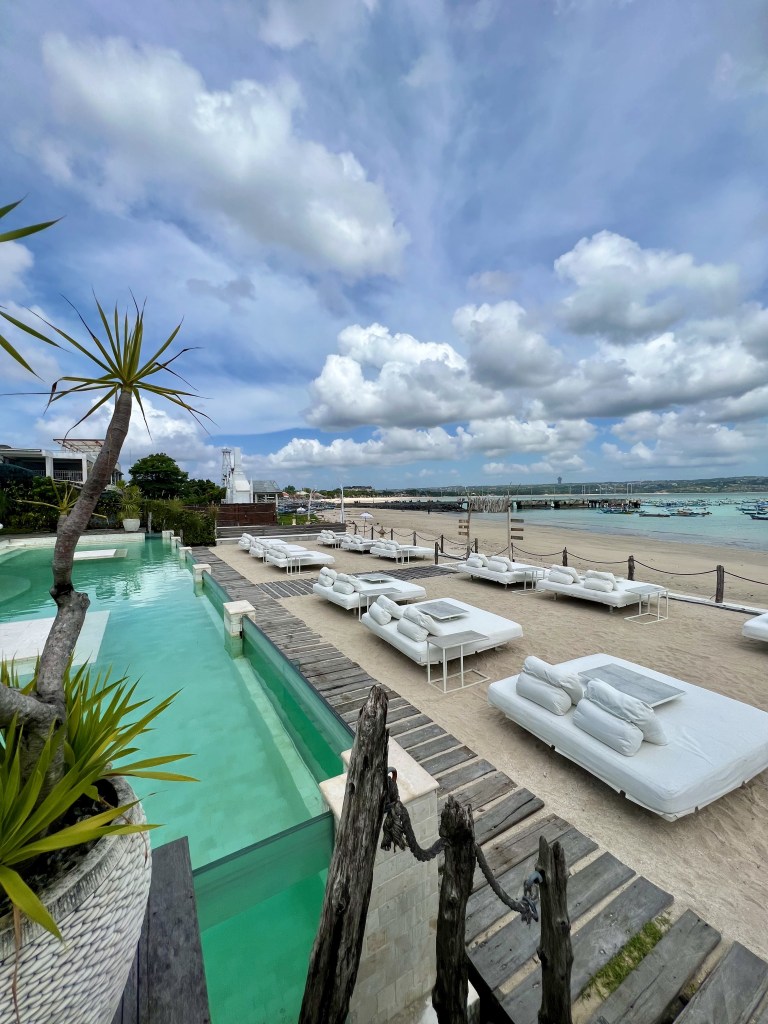 The infinity pool and beach at IBIZA Hotel, Bali, one thing to do in Bali to make your escape unforgettable 