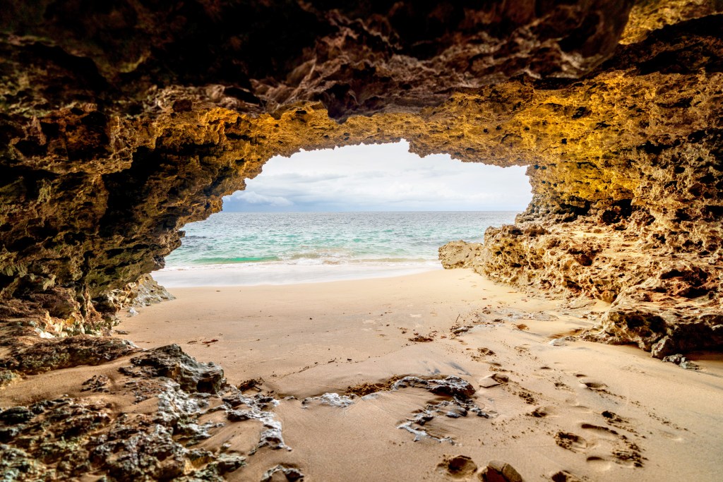 A cave at Tegal Wangi Beach, one of the best things to do to make your Bali escape unforgettable