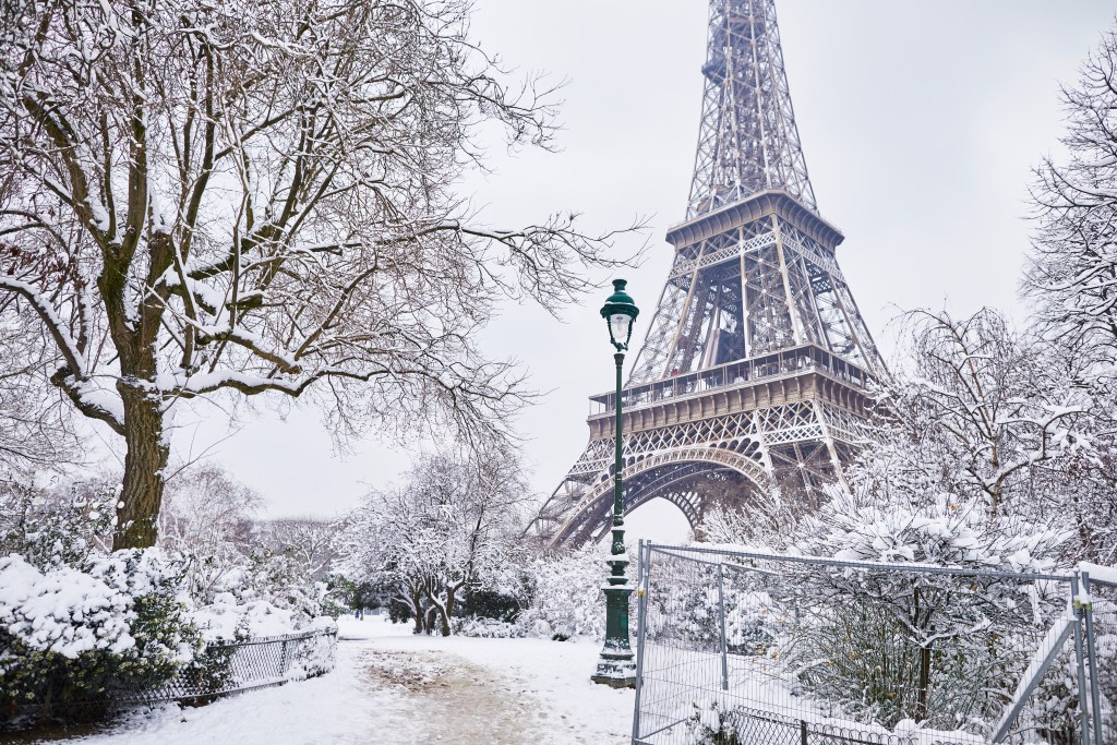 A snowy Eiffel Tower, one of the best reasons to visit Europe at Christmas - Luxury Escapes 