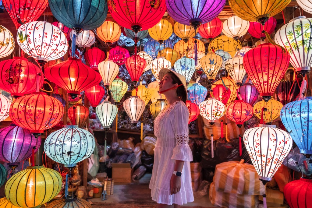 A person looks at colourful lanterns in Hoi An, Vietnam, during the lunar celebration - Luxury Escapes