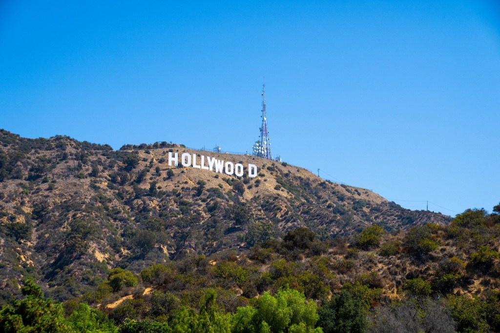 The Hollywood Sign is an American landmark and cultural icon overlooking Hollywood, Los Angeles, California - Luxury Escapes