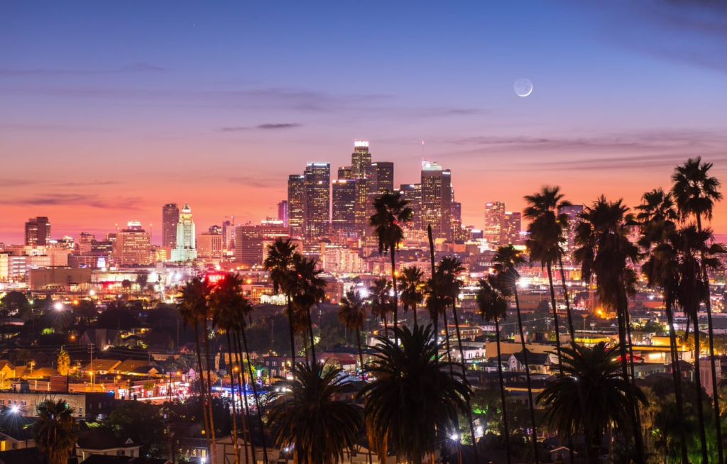 Stunning sunsets across the glittering skyline are just one of the magical experiences you'll have when you stay and play in Los Angeles - Luxury Escapes