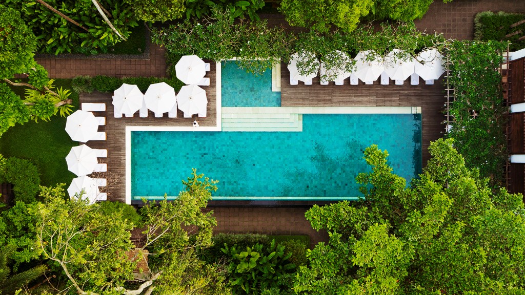 An aerial shot of the COMO Uma Ubud's main pool, one of Bali's most luxurious resorts - Luxury Escapes