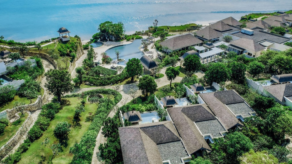 A shot from high of some of Jumeirah Bali's opulent villas, lagoon pool and pristine beachfront - all part of one of Bali's most luxurious resorts - Luxury Escapes
