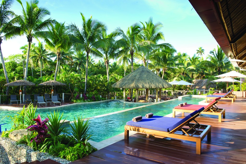 The swim-up bar and pool at Outrigger Fiji Beach Resort, one of the best family resorts in Fiji - Luxury Escapes