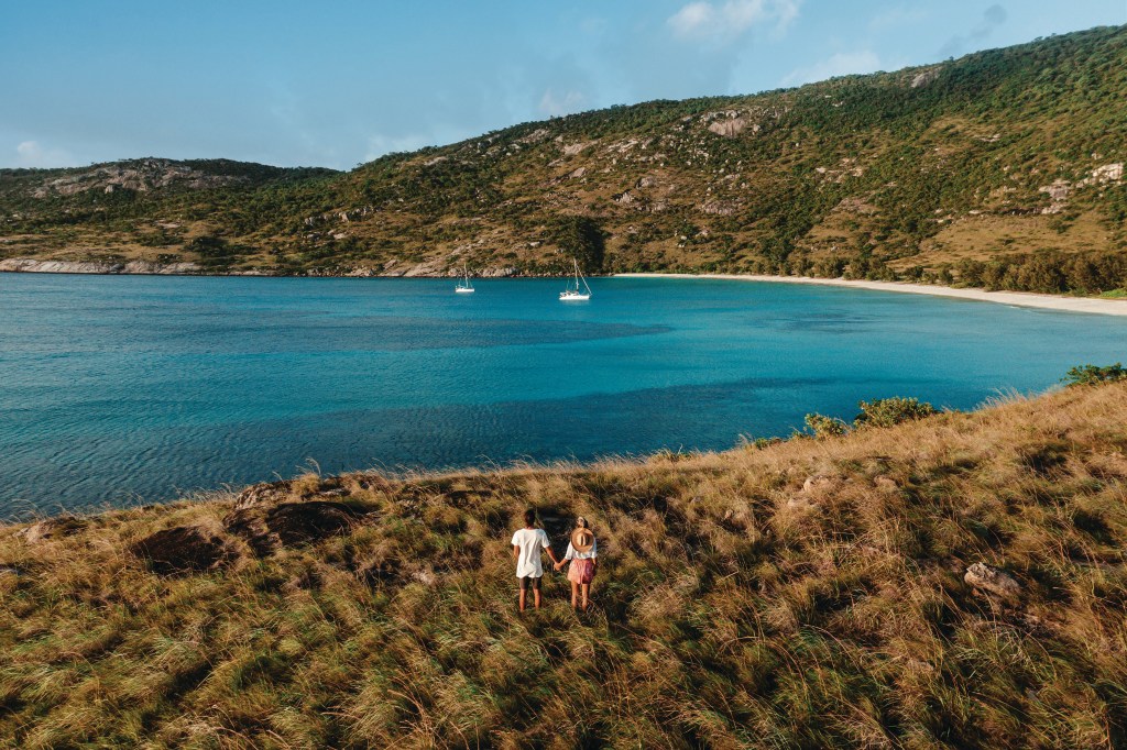 A couple exploring Lizard island, great barrier reef, one of Queensland's most unique locations - Luxury Escapes