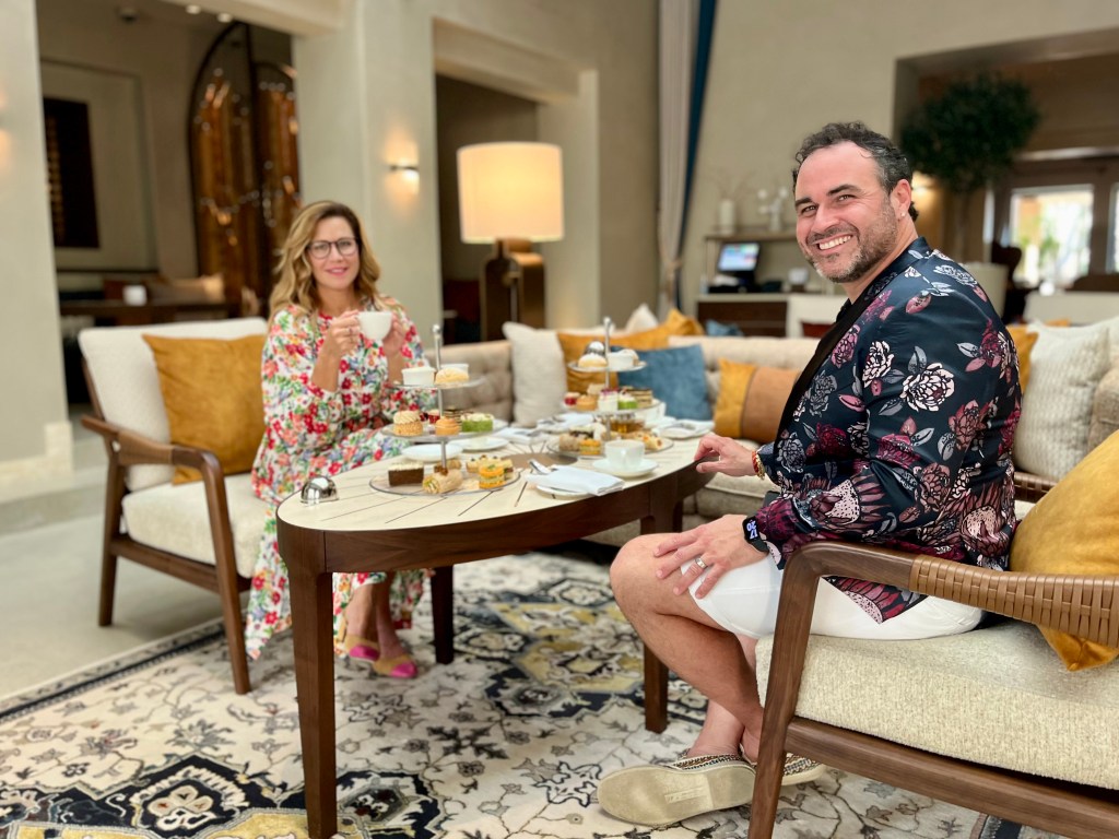 Chef Miguel Maestre and actress Jane Hall, hosts of Luxury Escapes: The World's Best Holidays, enjoying afternoon tea, one of the best things to do in Dubai - Luxury Escapes